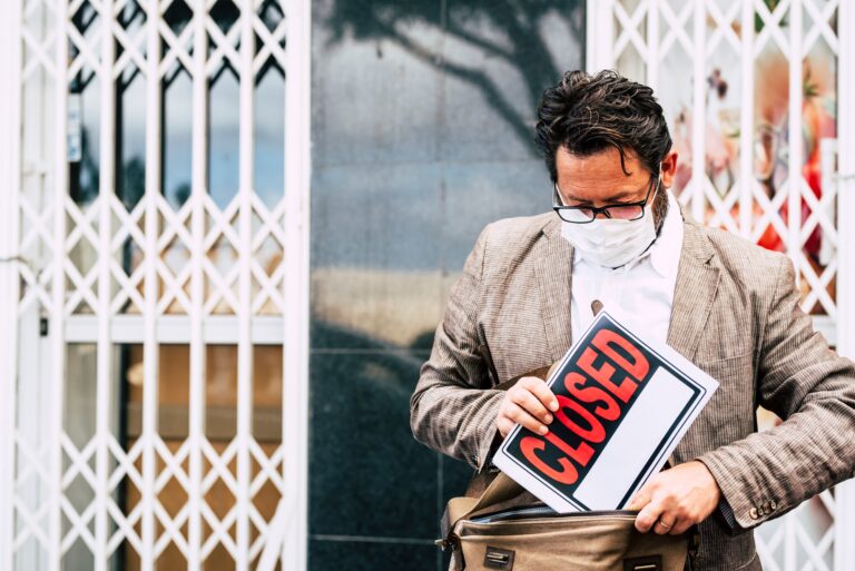 Failed business store man with on sale sign outside his store